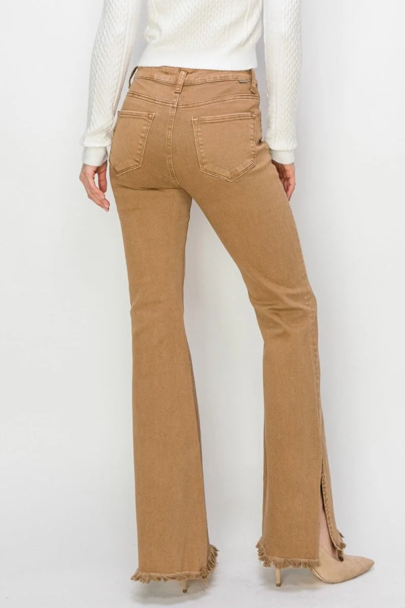 High-waisted, flared jeans in a warm tan with frayed hems and a side slit.