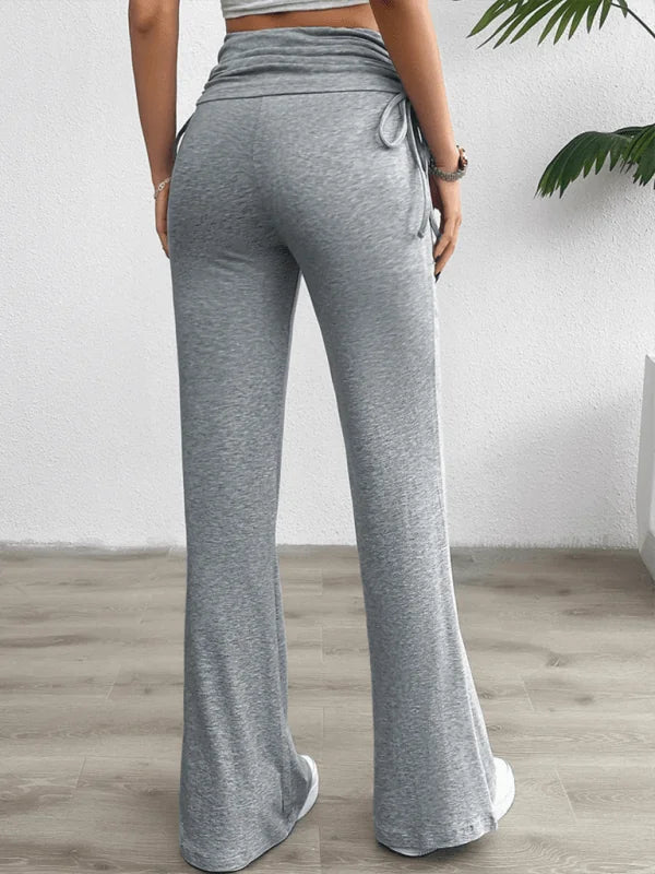 Back view of grey, wide-leg, drawstring pants with a textured waistband.