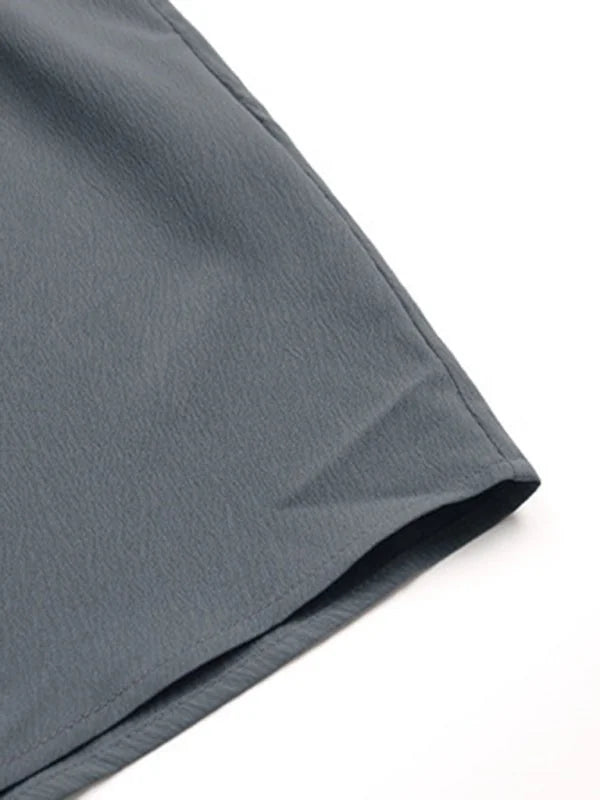 Close-up of the button detail on a charcoal grey shirt dress
