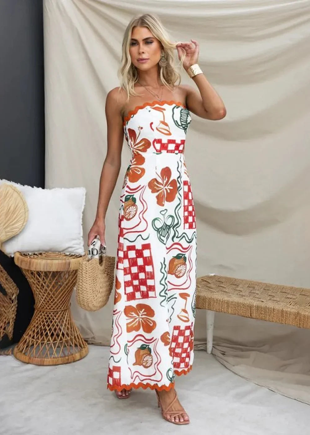 Strapless white dress with orange and green floral and checkered print, scalloped hem, on model.