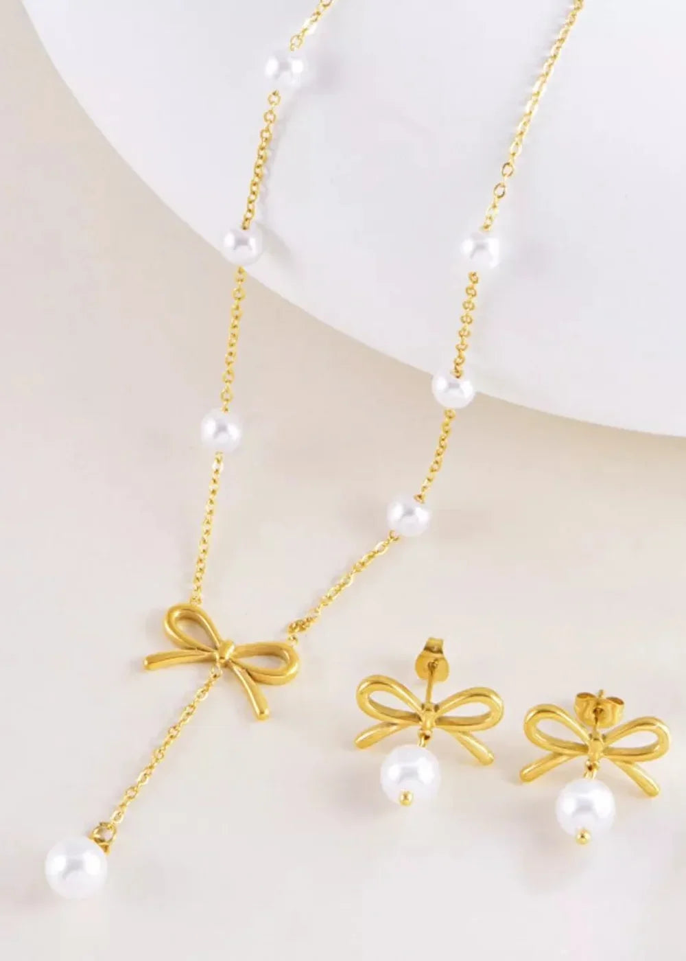 Close-up of pearl pendant and bow detail