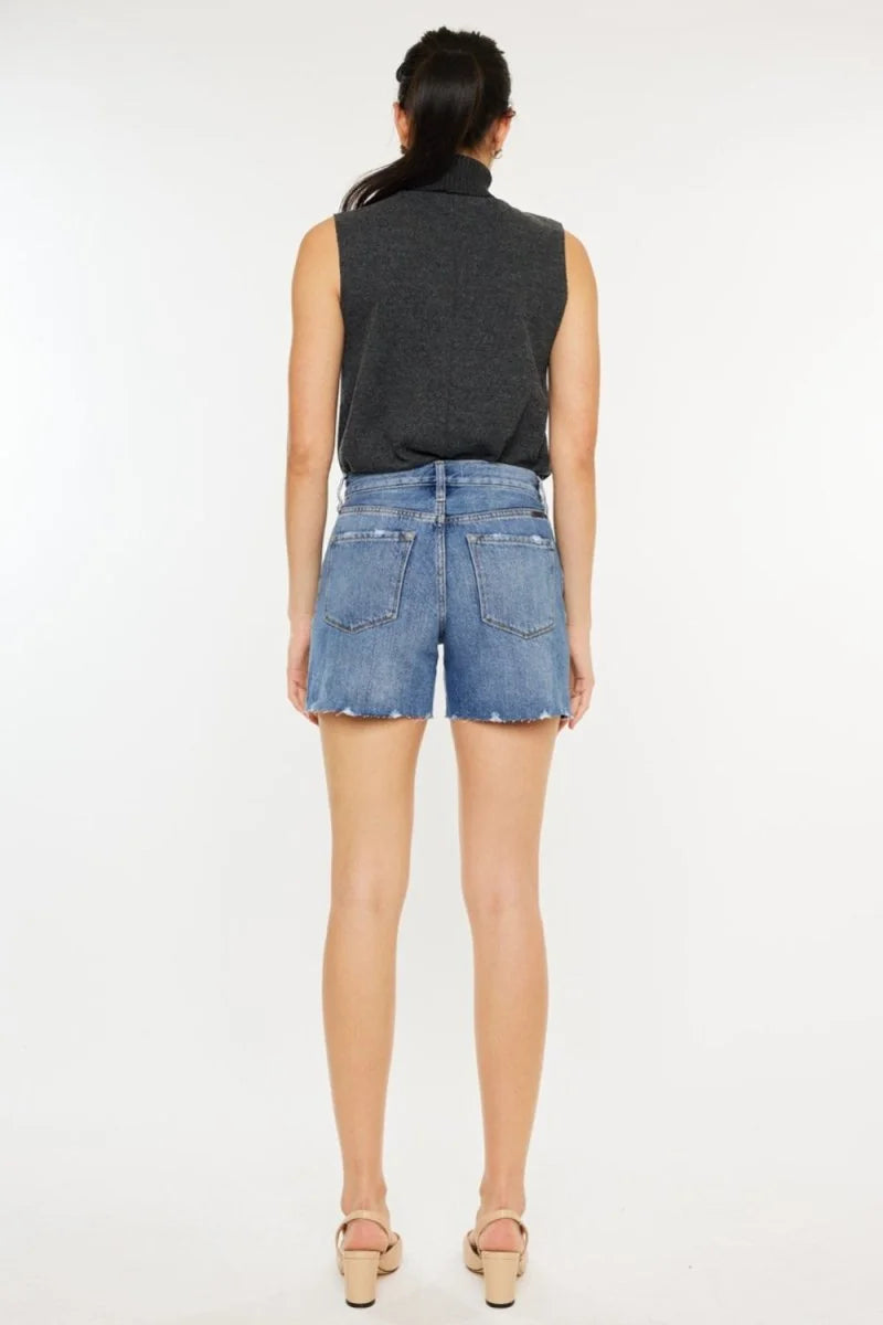 Close-up of distressed denim shorts hem