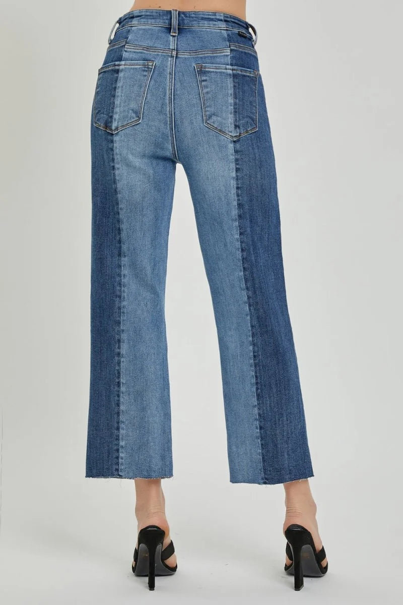 Back view of two-tone denim jeans with frayed hem and high heels.