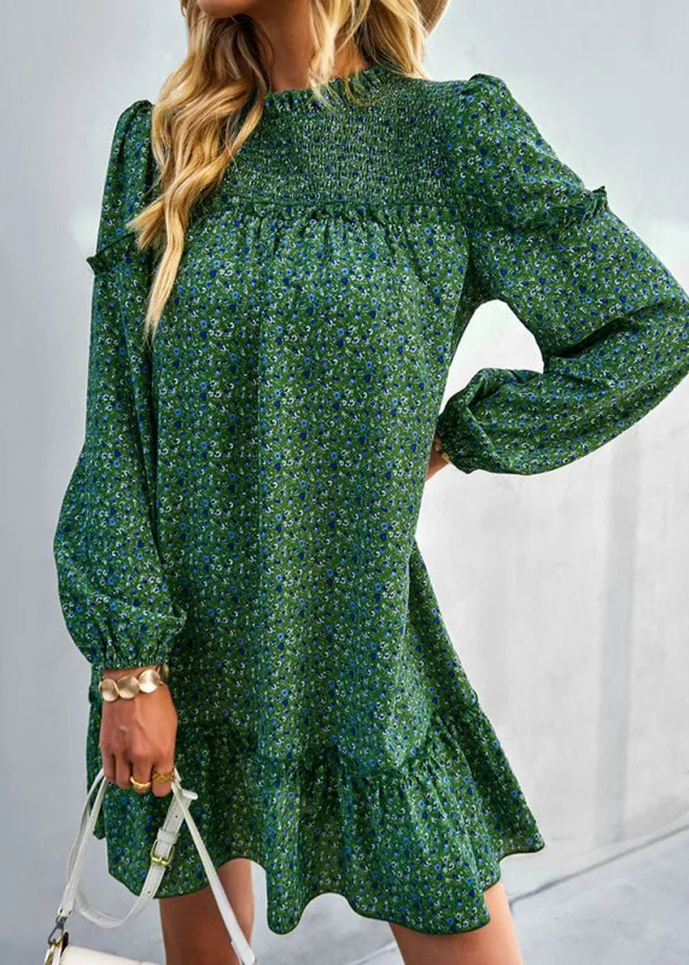 Green floral print dress with smocked neckline and ruffled hem, on a model.