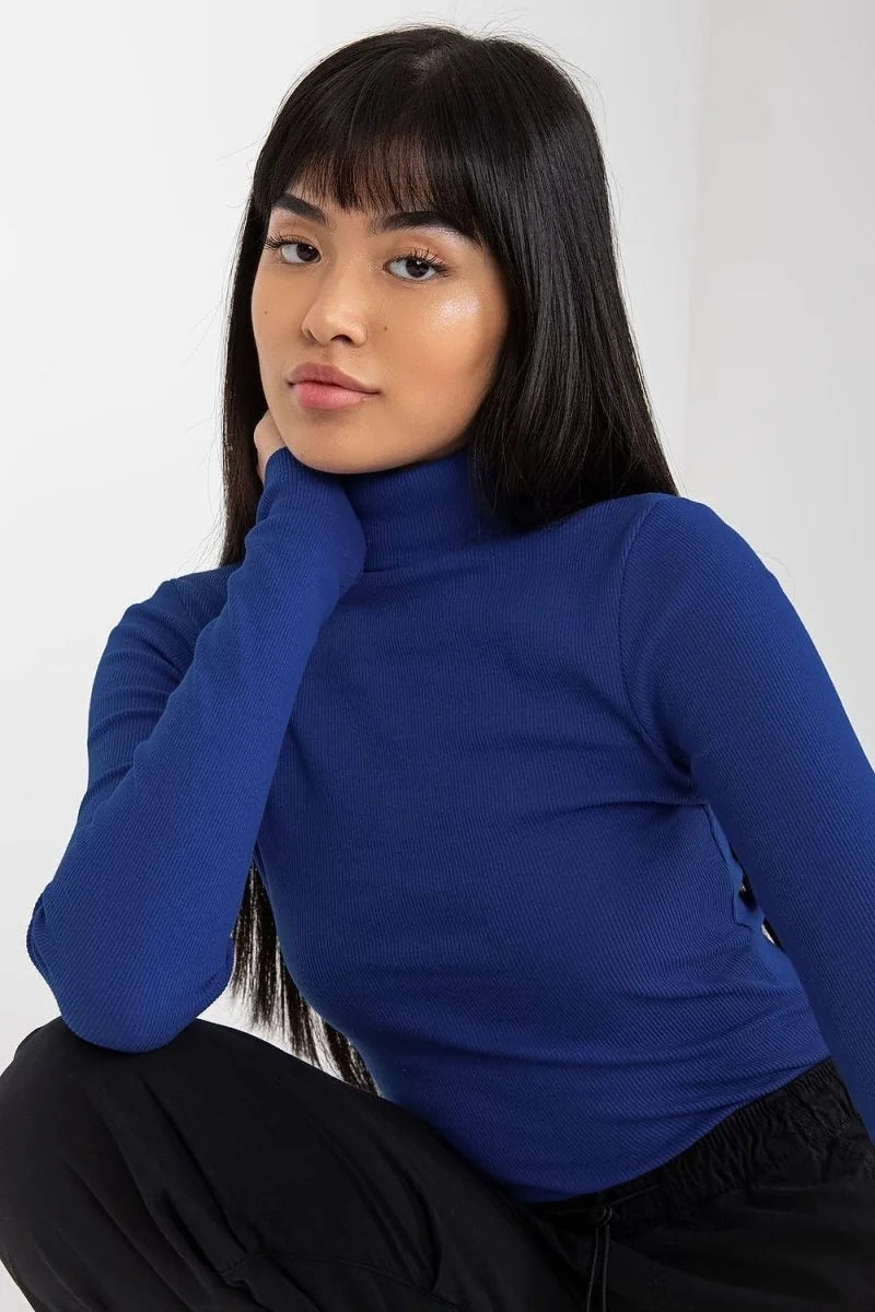 Fitted royal blue ribbed turtleneck top with long sleeves, shown on a model.