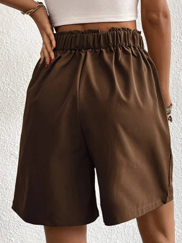 Brown paperbag waist shorts with a relaxed fit and subtle sheen.