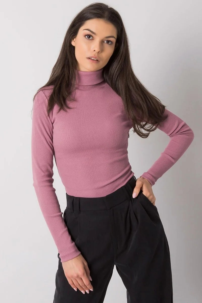 Fitted rose pink ribbed turtleneck top with long sleeves, shown on a model.