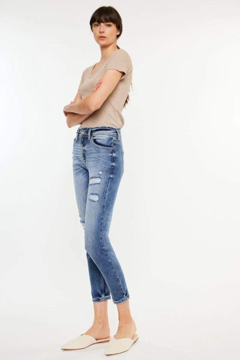 Medium wash distressed denim jeans with a slightly stretchy fit on a model.