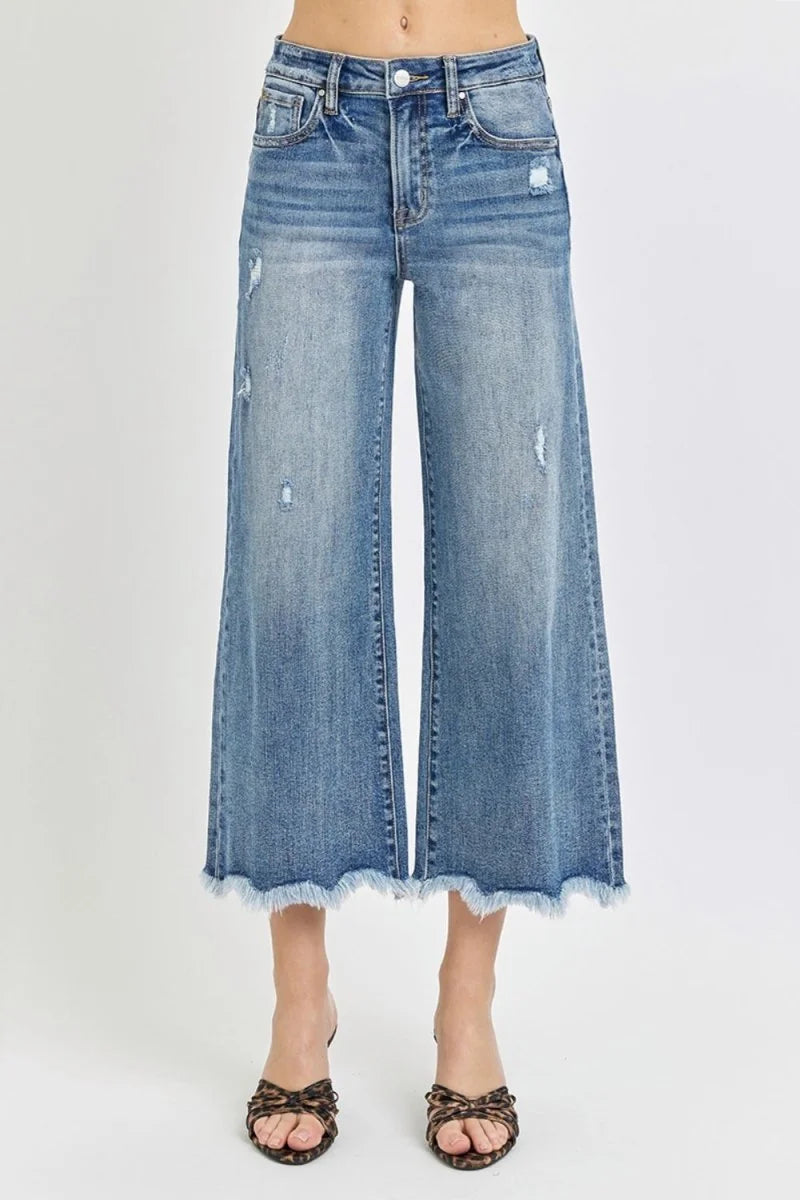 Distressed light wash denim culottes with a frayed hem and a regular fit.