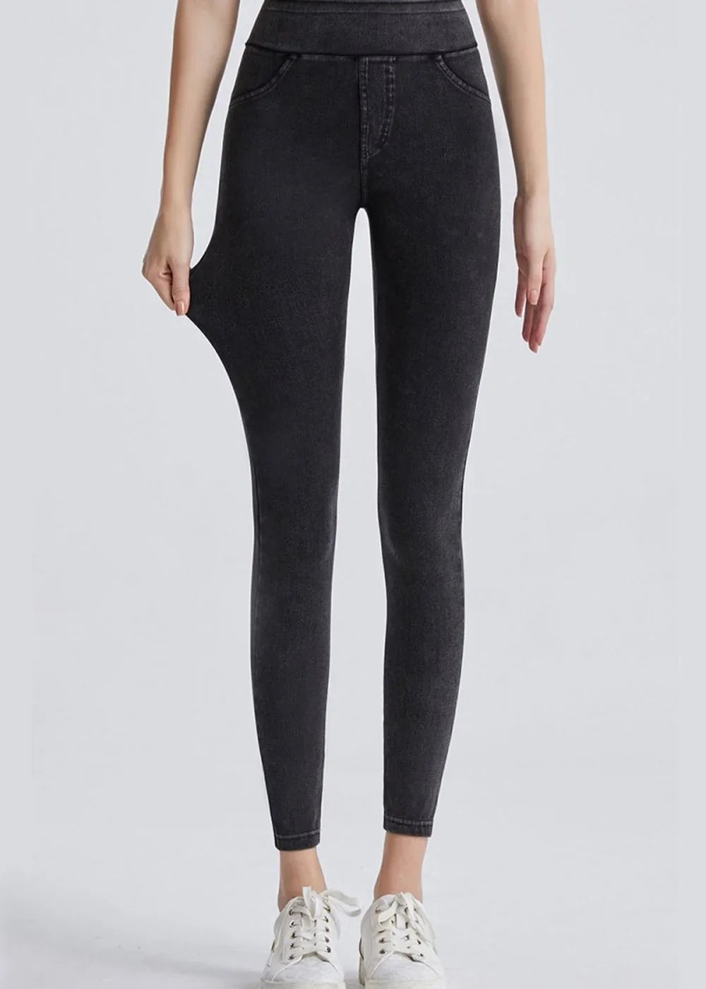 Dark wash, stretchy denim-look leggings with faux pocket details, shown full length on a model.