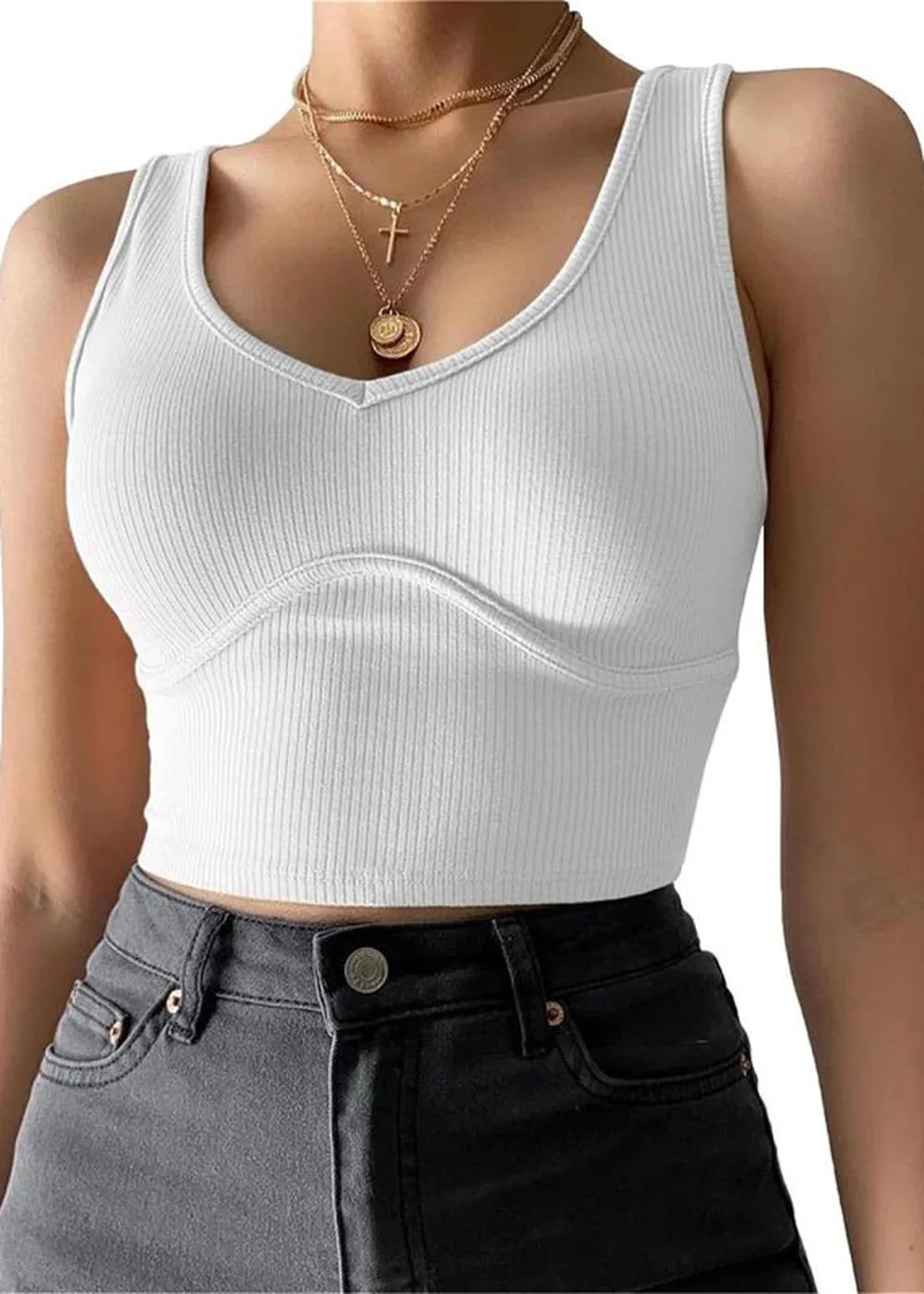 White ribbed cropped tank top with V-neck and layered gold necklaces.