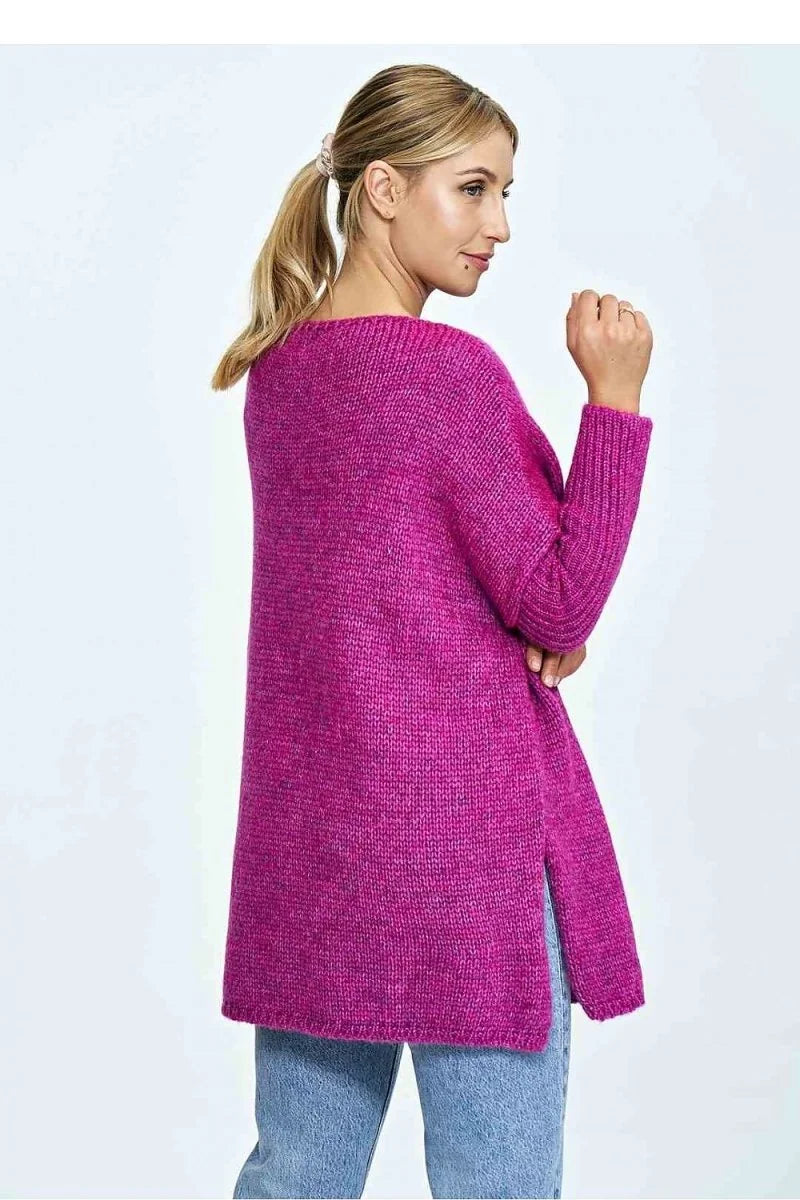 Woman in a loose-fit, magenta knit sweater with side slits, shown from the back.
