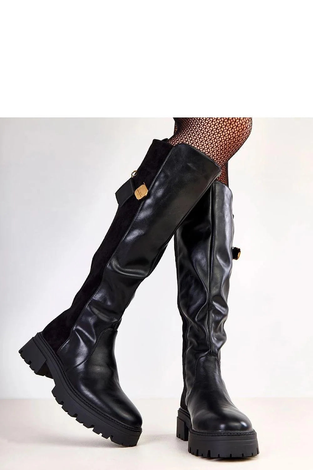 Model wearing black knee-high boots