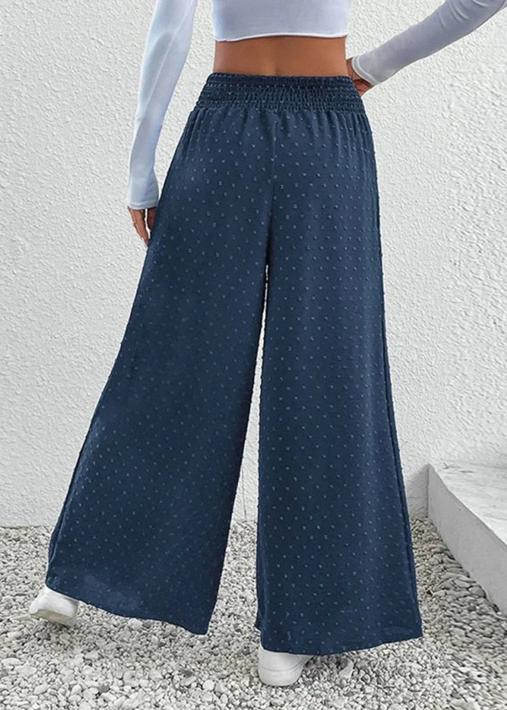 Navy blue wide-leg pants with a subtle dot pattern and smocked waistband.