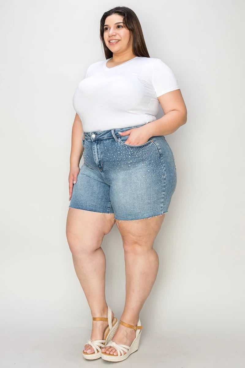 Light wash denim shorts with rhinestone embellishments and frayed hem.