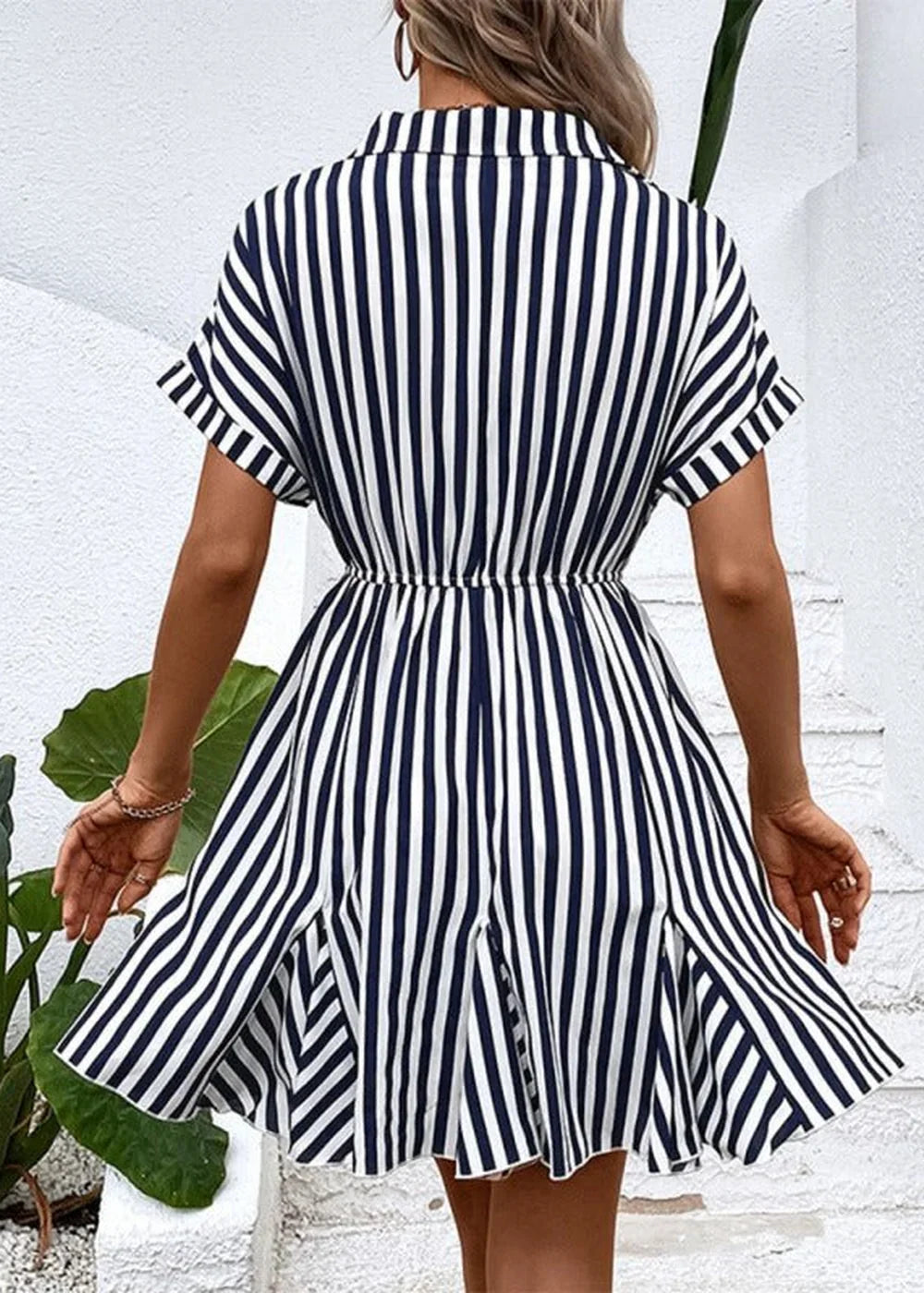 Model wearing a striped shirt dress