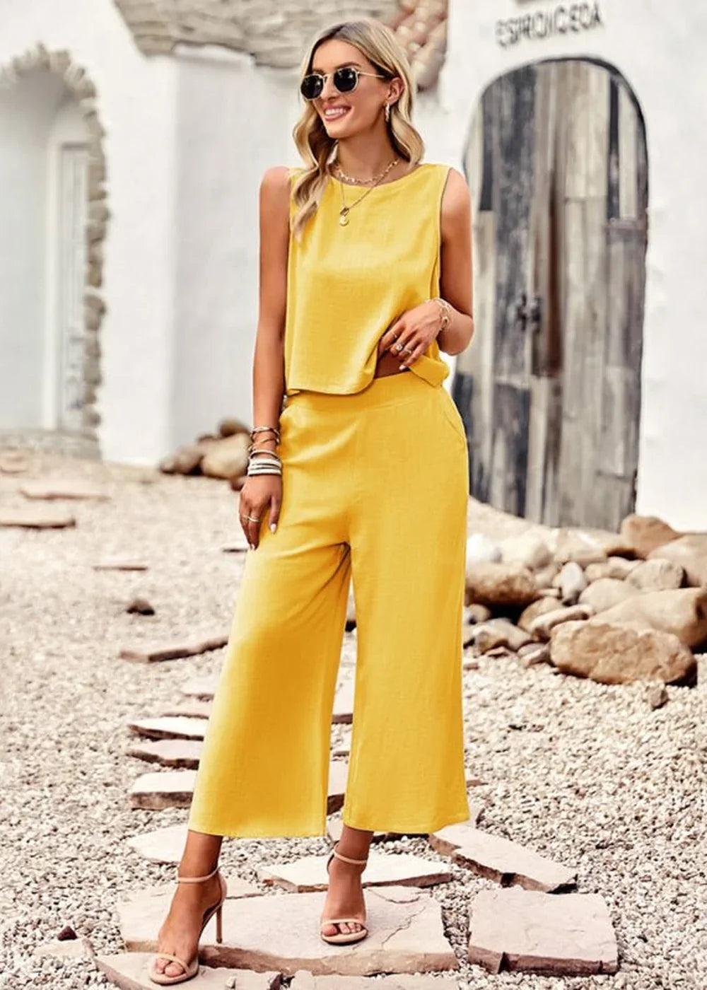 Yellow sleeveless crop top and wide-leg pants set on a woman, showing a relaxed fit.