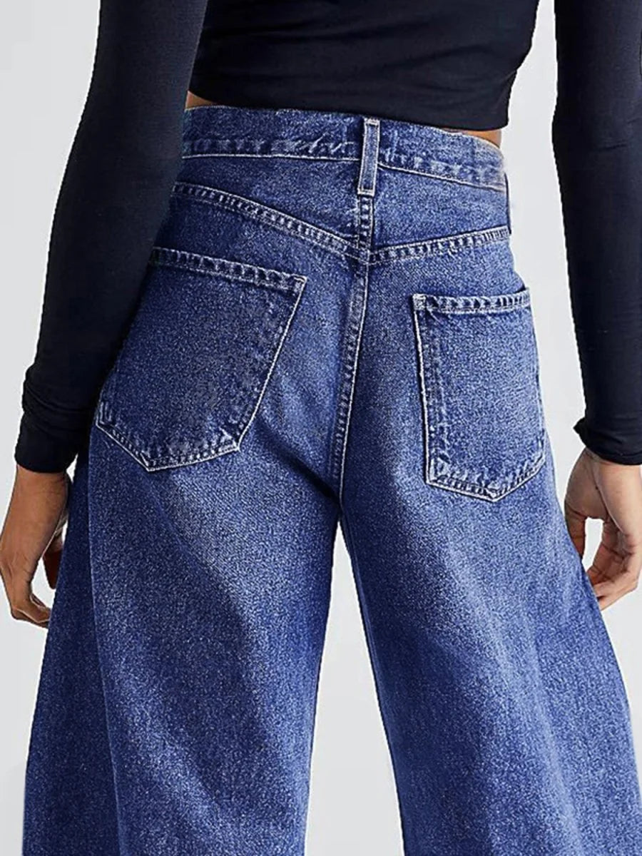 Model wearing medium wash wide leg jeans
