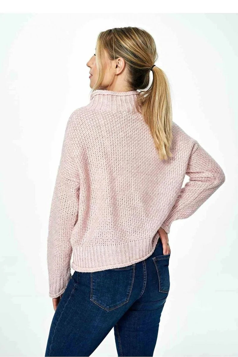 Pink textured knit sweater with a mock neck and a relaxed fit.