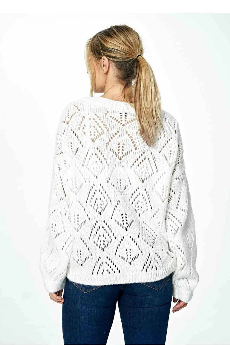 White open-knit sweater with diamond pattern and dark wash jeans, shown from the back.