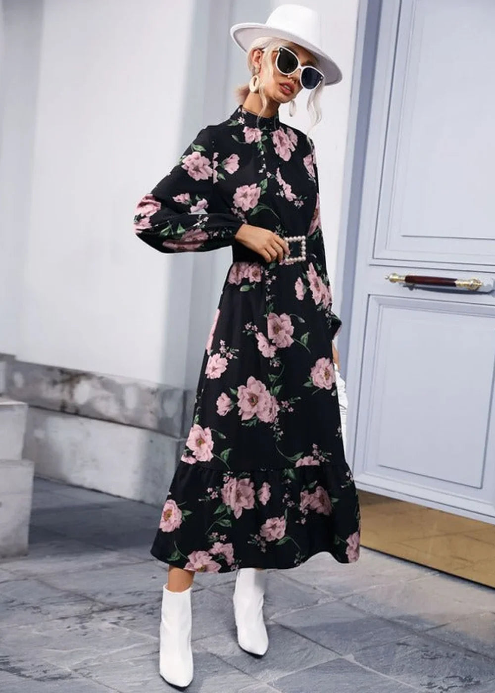 Black floral print maxi dress with balloon sleeves, white belt, and white boots on model.