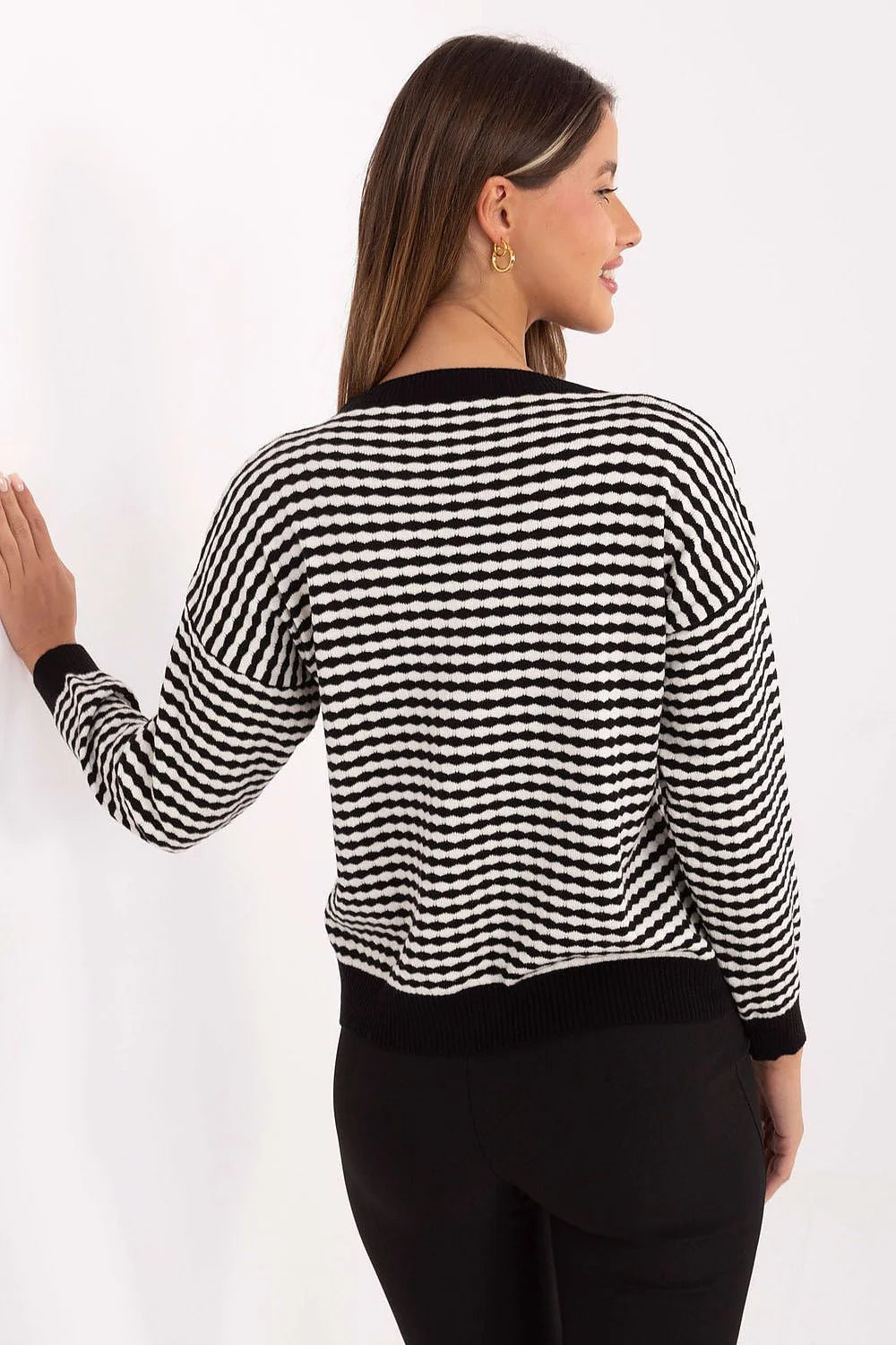 Black and white striped knit sweater with a textured pattern and black trim.