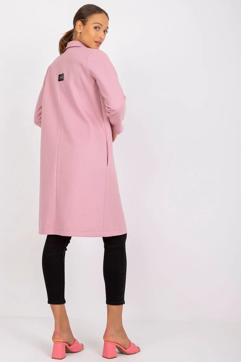 Pink longline blazer with a black patch on the back, worn by a model.