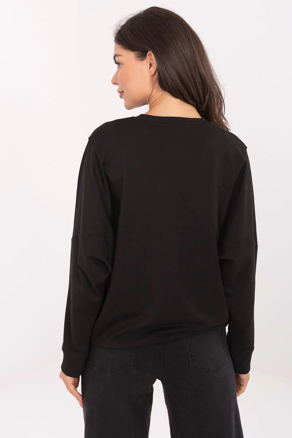 Black long-sleeve sweatshirt with visible seam detail on sleeves, worn with dark wash jeans.