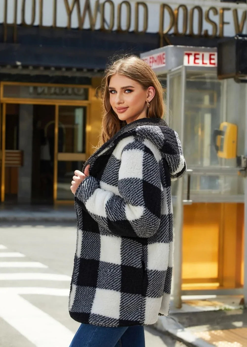 Black and white buffalo plaid fuzzy hooded jacket on a model.