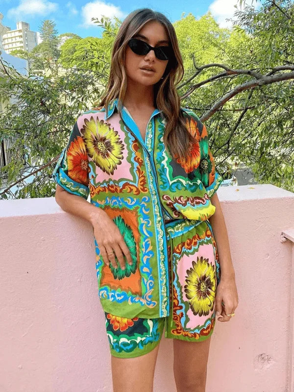 Vibrant floral print linen-blend short suit with bold colors like green, pink, orange, and yellow.