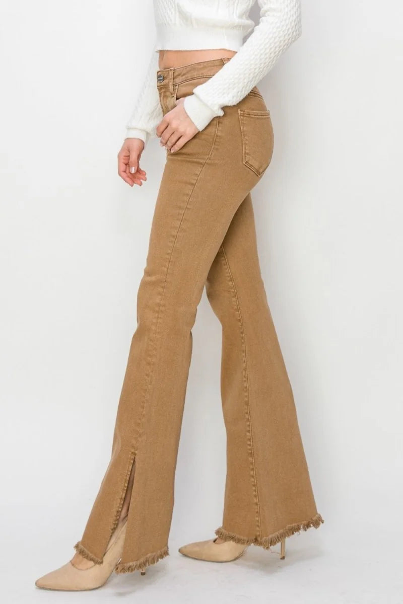Brown high-waisted flare jeans with frayed hem and front slit, worn with nude heels.