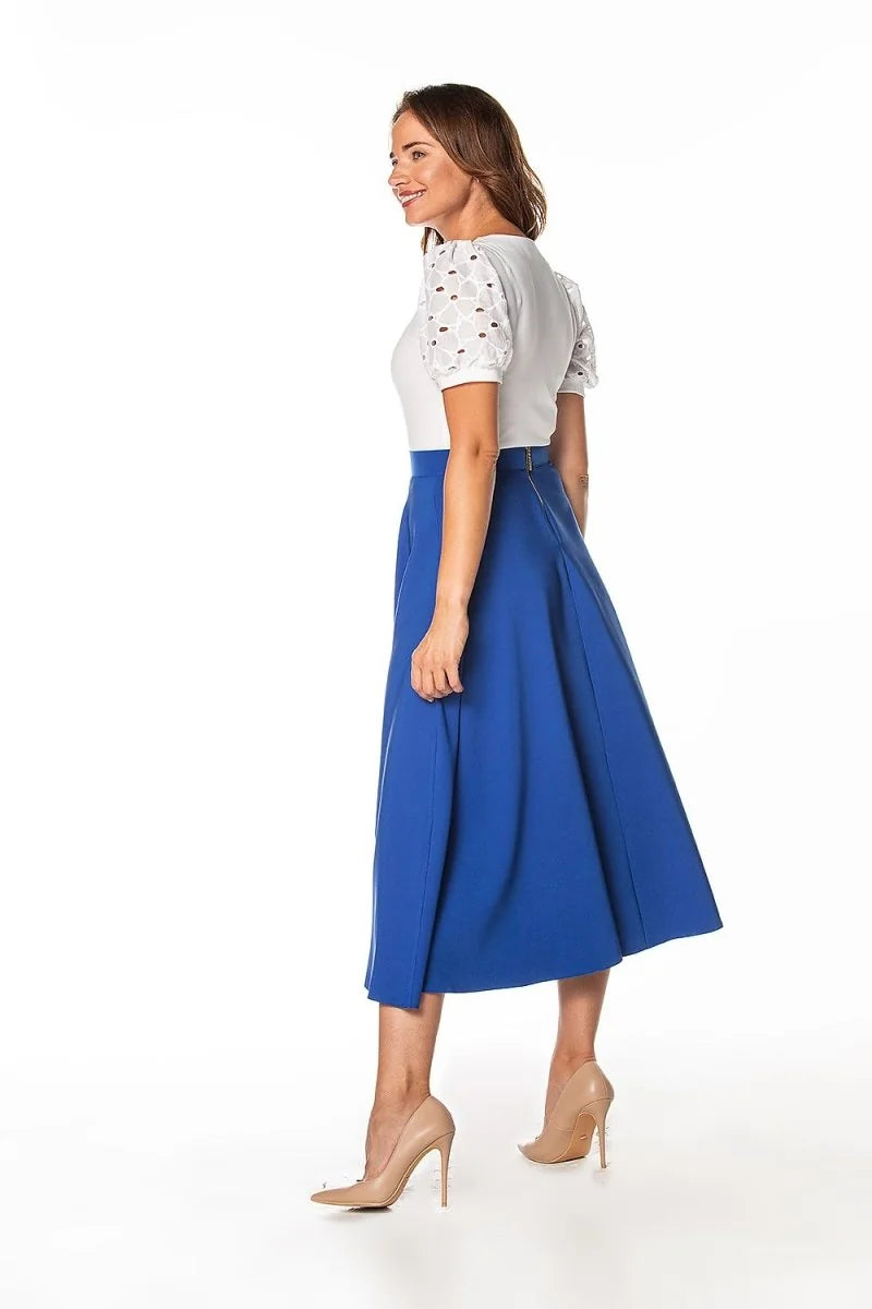 Royal blue midi skirt with a flattering A-line silhouette and subtle sheen, worn with nude pointed-toe pumps.
