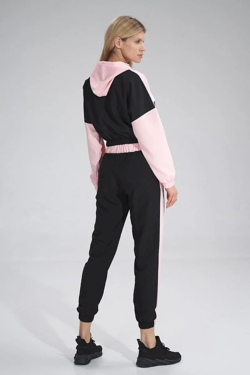 Black and pink striped tracksuit with hoodie and joggers, worn by a woman.