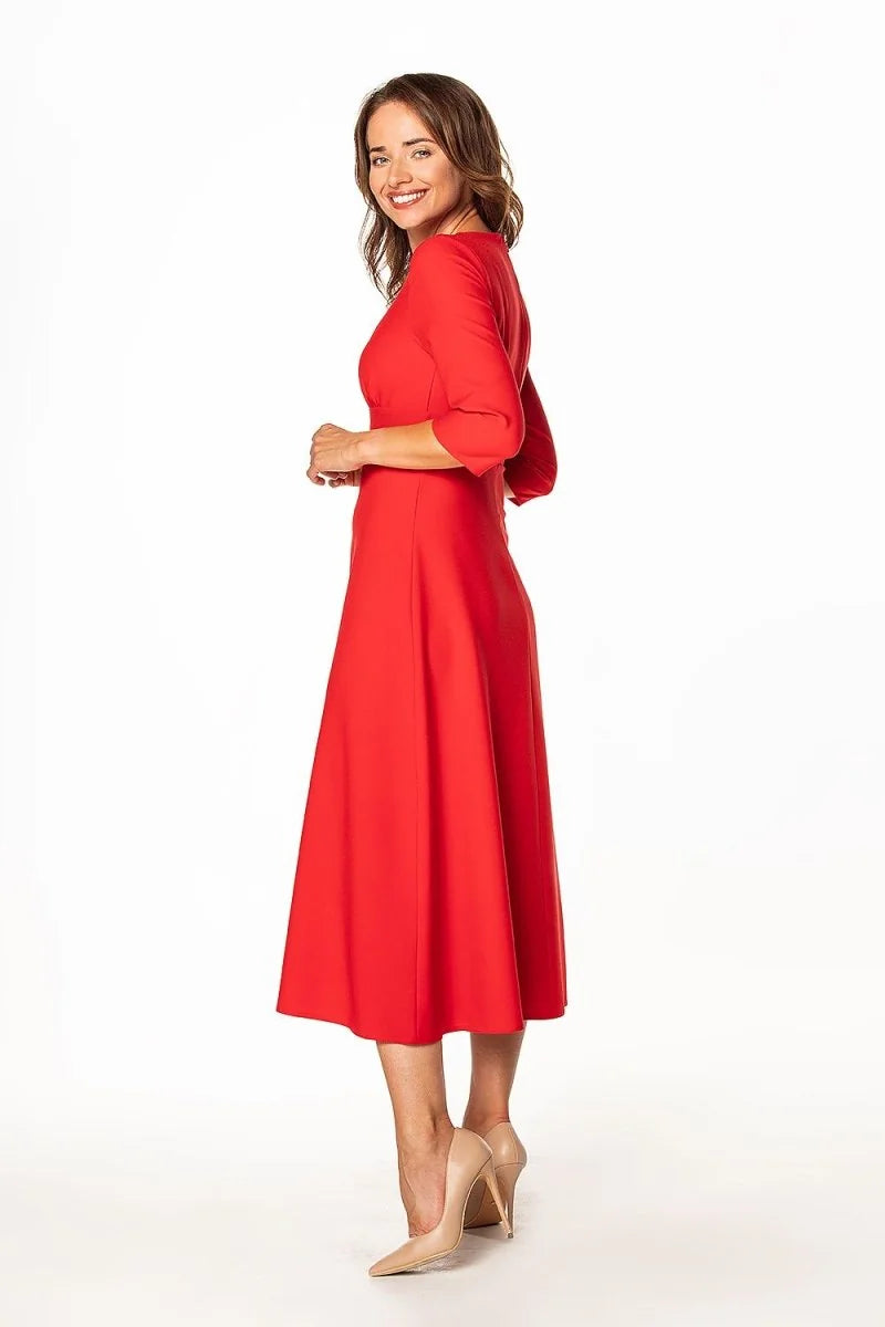 Red midi dress with three-quarter sleeves and pointed nude heels on a white background.