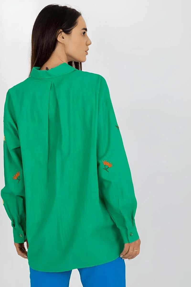 Green loose-fit cotton blend shirt with embroidered orange flowers on sleeves, back view.
