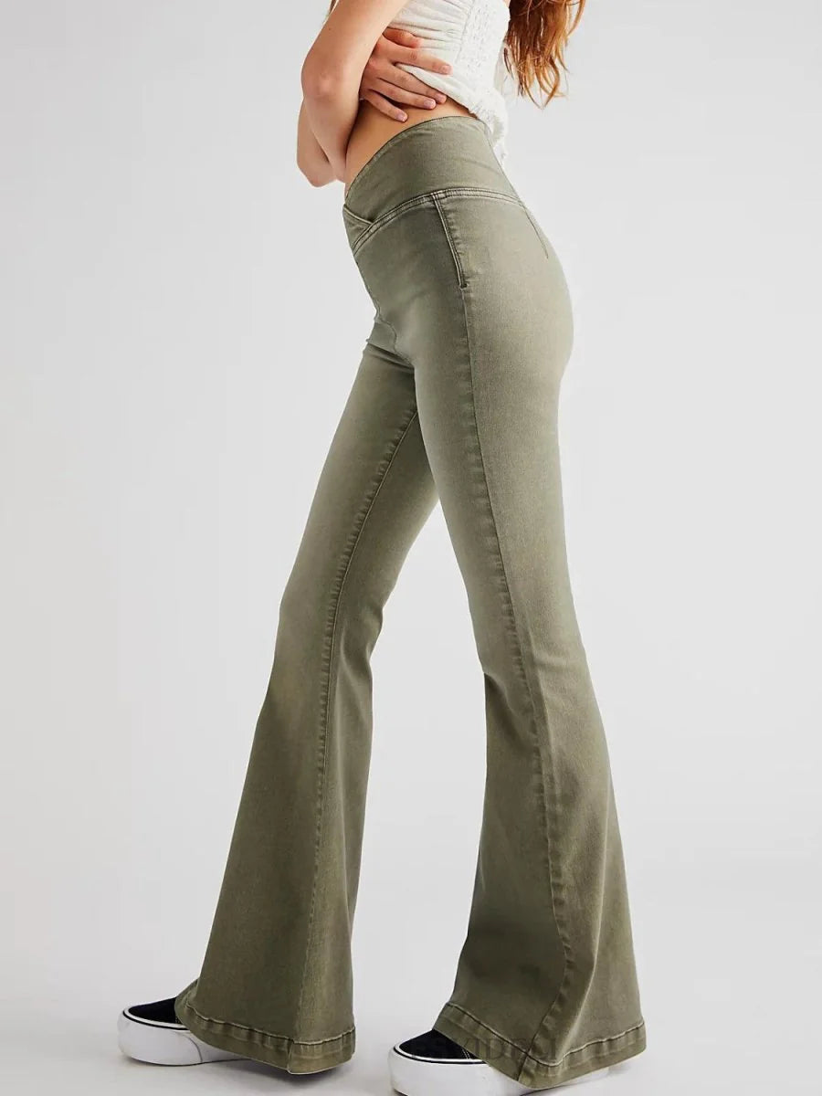 Moss green flared jeans with a high waist and platform sneakers on model.