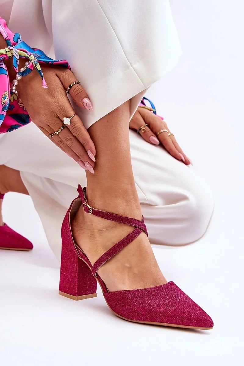 Sparkling fuchsia pointed-toe heels with crisscross ankle straps and a chunky block heel.