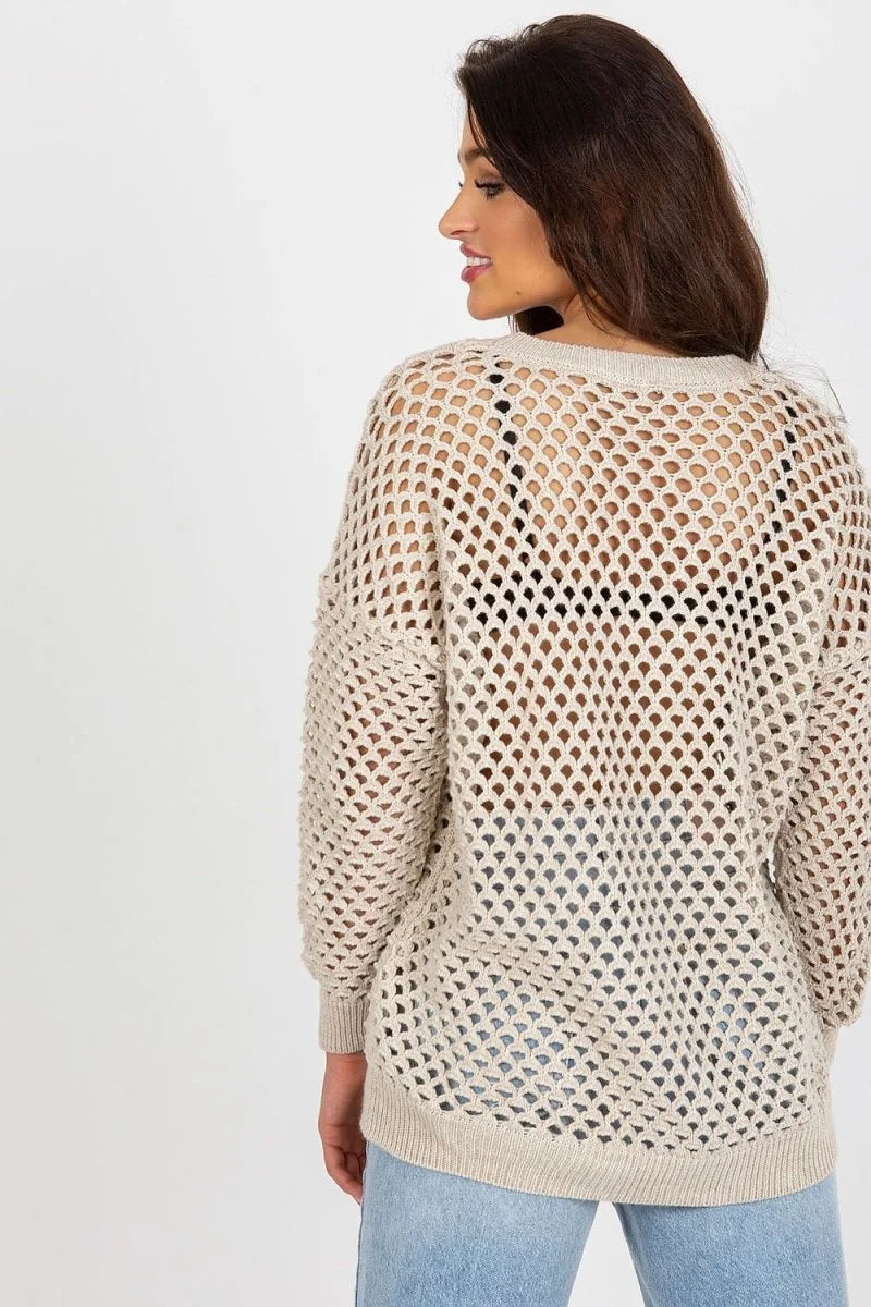 Beige crocheted oversized sweater with a black bra visible underneath, worn by a model from the back.