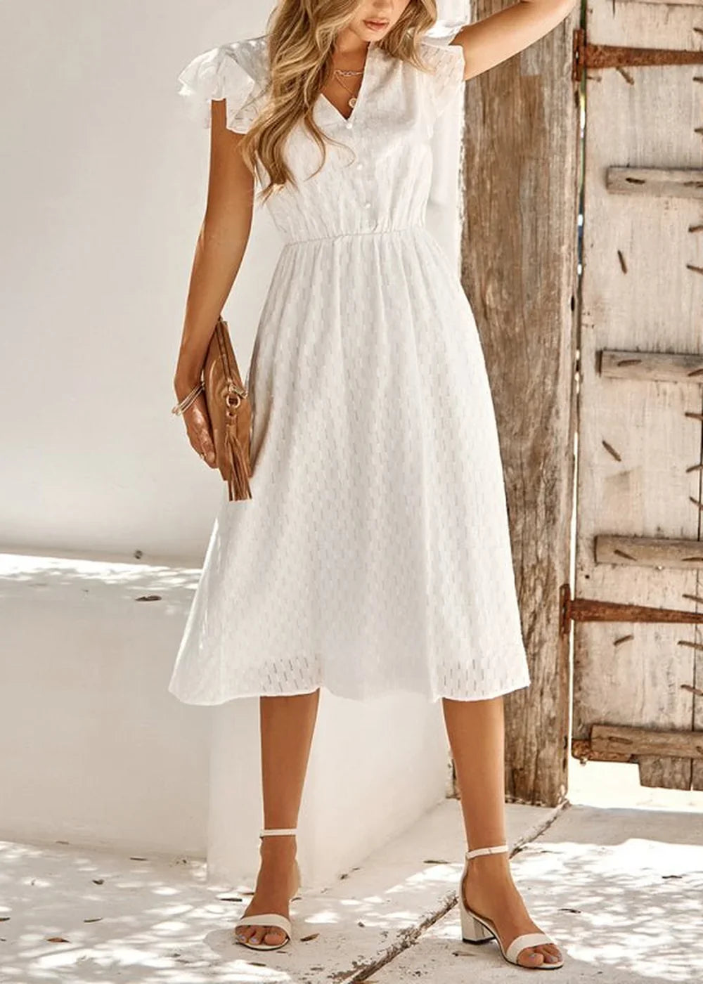 Model wearing a white V-neck cotton dress