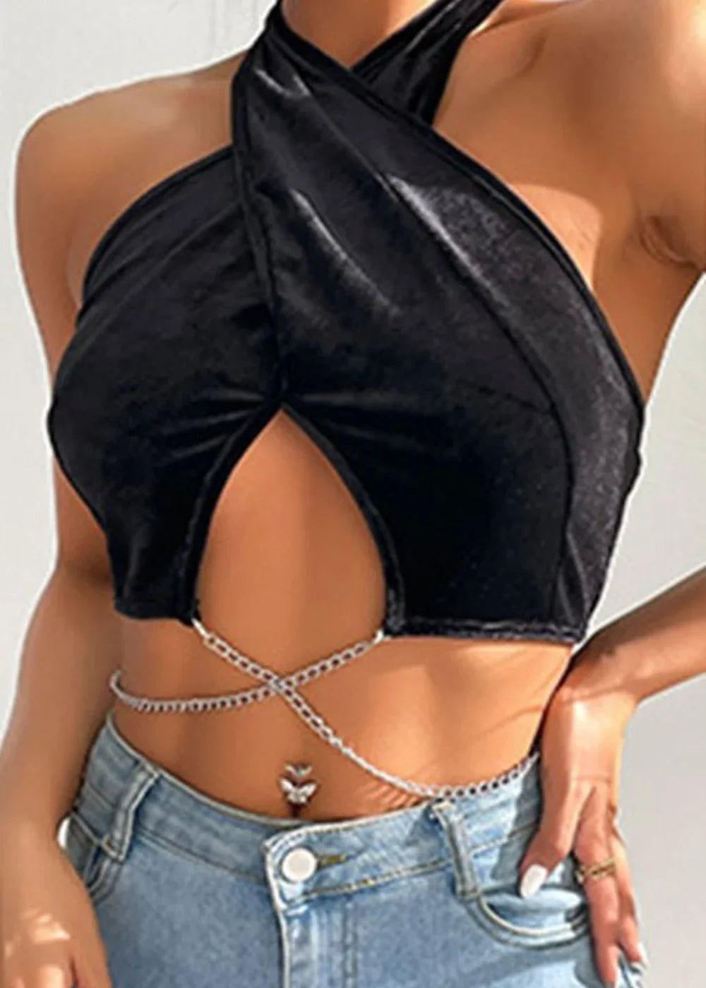 Black velvet halter top with chain detail and butterfly belly ring on model