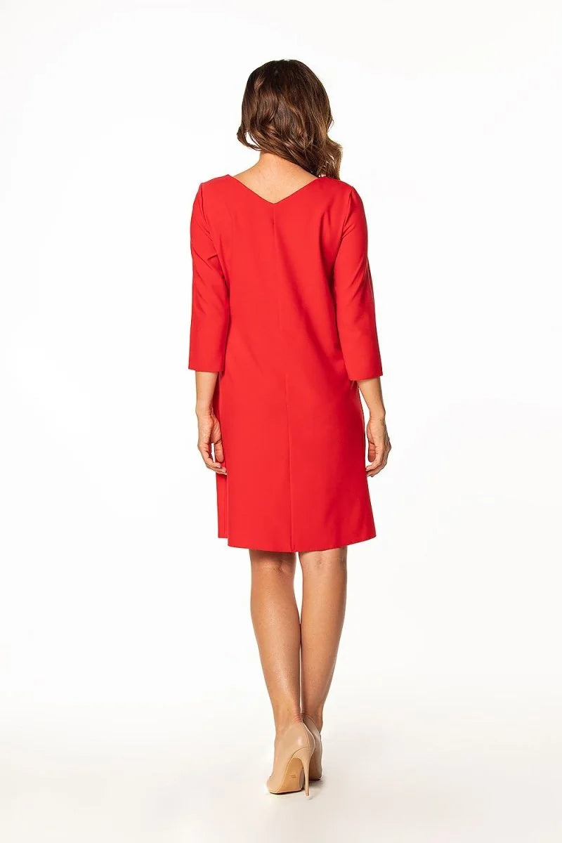 Back view of a red dress with 3/4 sleeves and nude high heels.