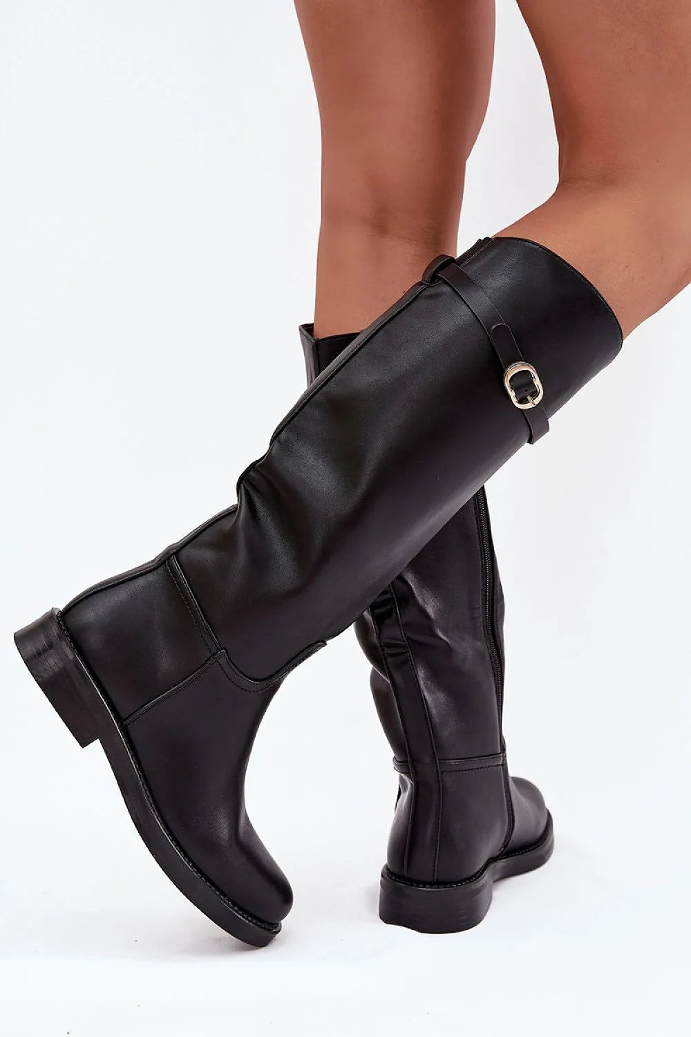 Black faux leather knee-high boots with buckle detail.