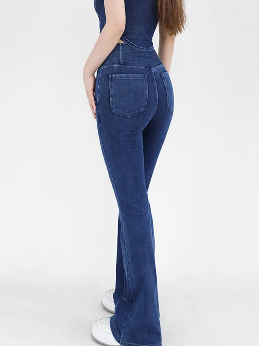 Dark wash flared denim jeans with a fitted waist and square back pockets.