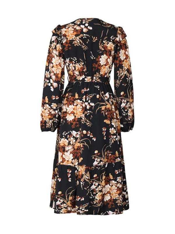 Black dress with brown and cream floral print, long sleeves, and tiered skirt.