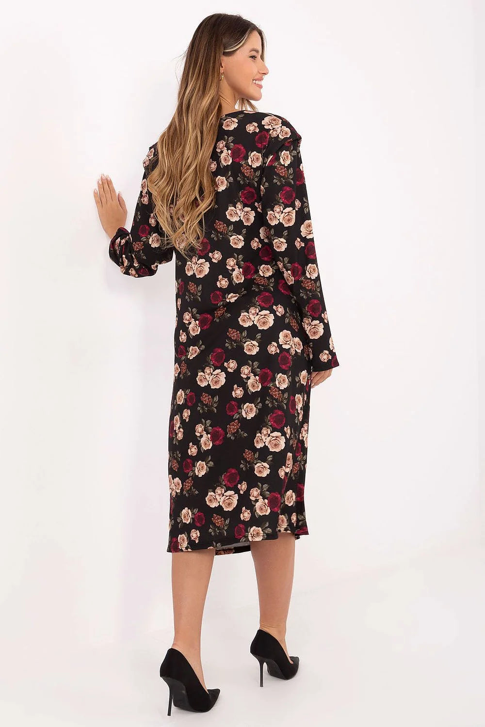 Black dress with a floral pattern of red and beige roses, shown from the back on a model wearing black heels.