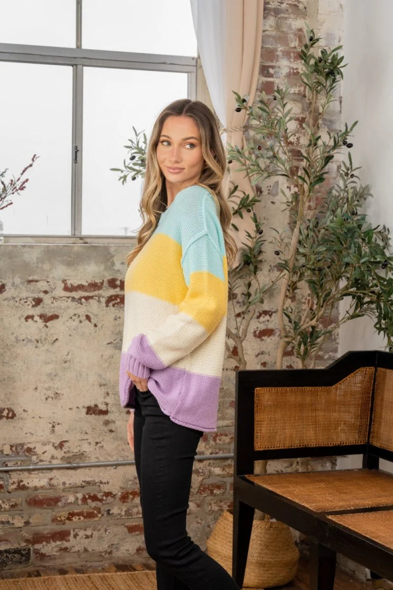 Striped cotton blend sweater in yellow, lilac, and cream with a relaxed fit on a model.
