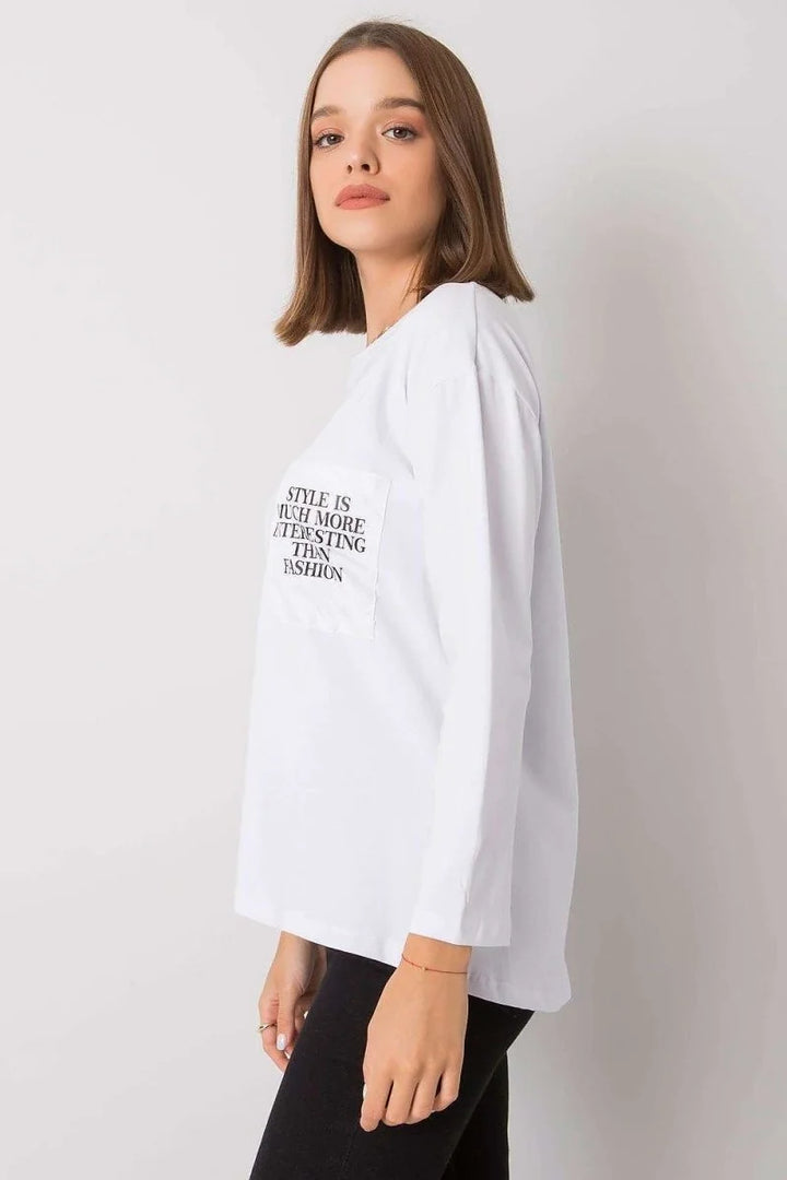 White cotton blouse styled with black pants