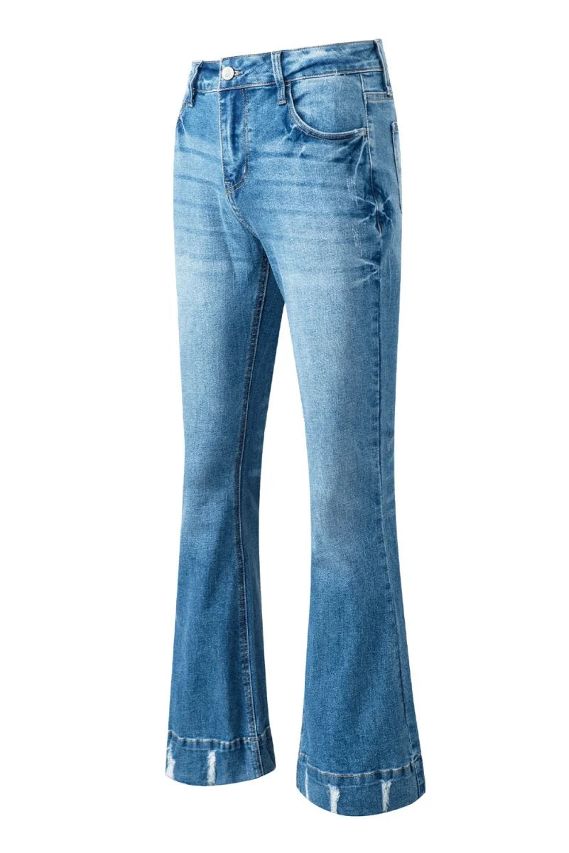 Light wash flared jeans with distressed hem and subtle textured detailing.