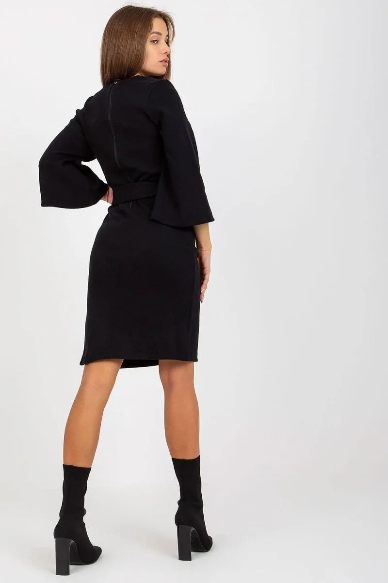 Black pencil-fit dress with bell sleeves, visible zipper detail on back, on model.
