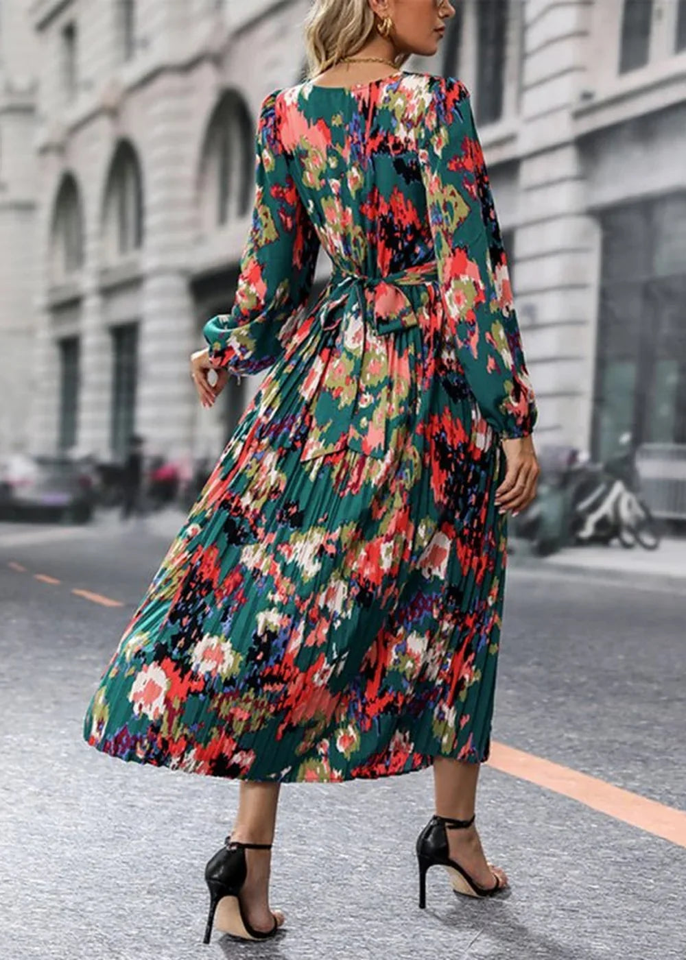 Green midi dress with a colorful abstract print, long sleeves, and a pleated skirt.